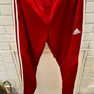 Woman’s Adidas red with white stripes pants size L